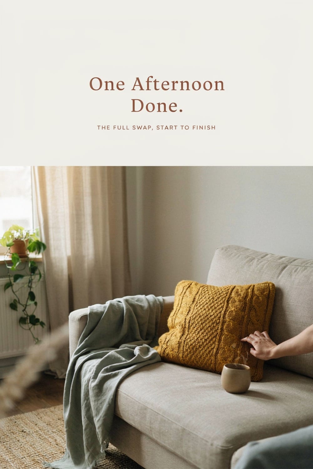 Hand adjusting a mustard accent pillow on a couch corner in warm light